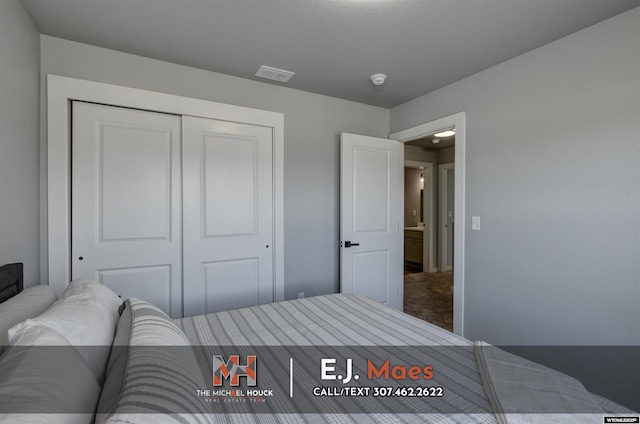 bedroom featuring a closet, visible vents, and carpet flooring