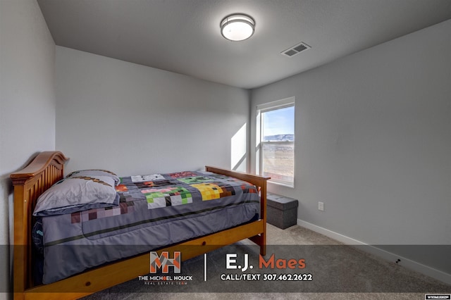 carpeted bedroom with visible vents and baseboards