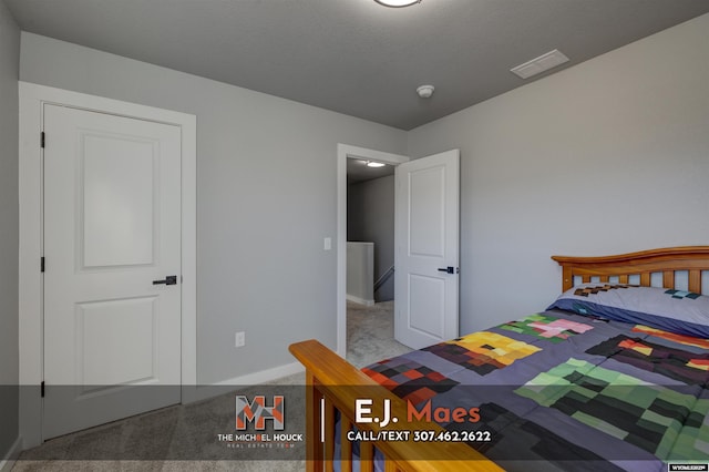 bedroom featuring visible vents, baseboards, and carpet