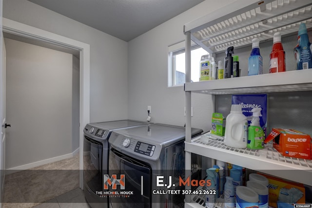 laundry area with laundry area, washing machine and dryer, baseboards, and carpet