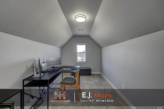 office space featuring baseboards, visible vents, lofted ceiling, a textured ceiling, and carpet flooring