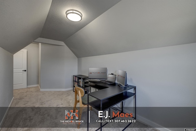 office with a textured ceiling, baseboards, carpet, and vaulted ceiling