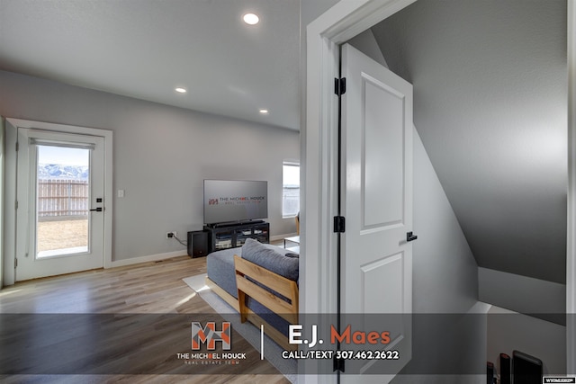 interior space with a wealth of natural light, recessed lighting, baseboards, and wood finished floors