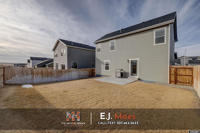 back of house with a patio, a lawn, and a fenced backyard