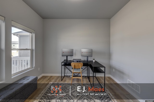 home office with visible vents, baseboards, and wood finished floors