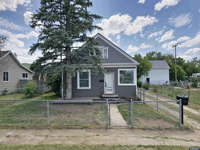 bungalow-style home with a fenced front yard and a gate