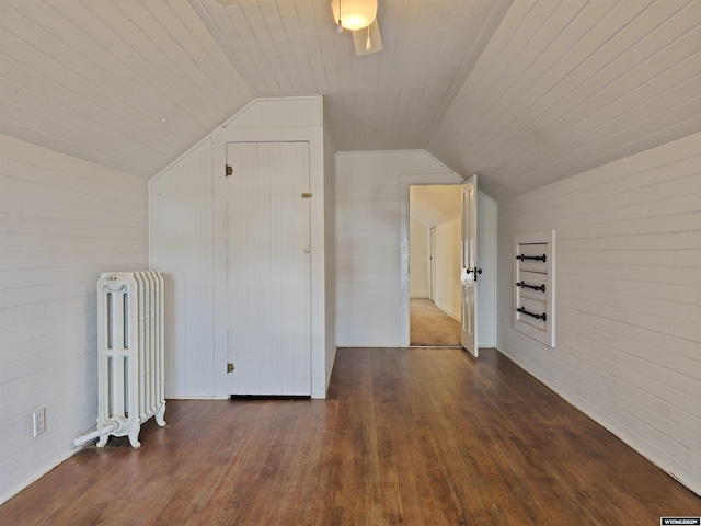 additional living space featuring wood finished floors, radiator heating unit, wooden ceiling, wood walls, and lofted ceiling