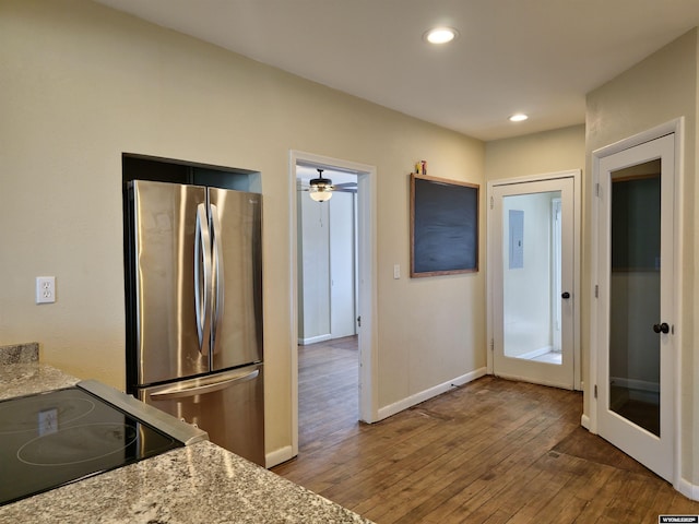 kitchen featuring hardwood / wood-style floors, baseboards, recessed lighting, freestanding refrigerator, and stove