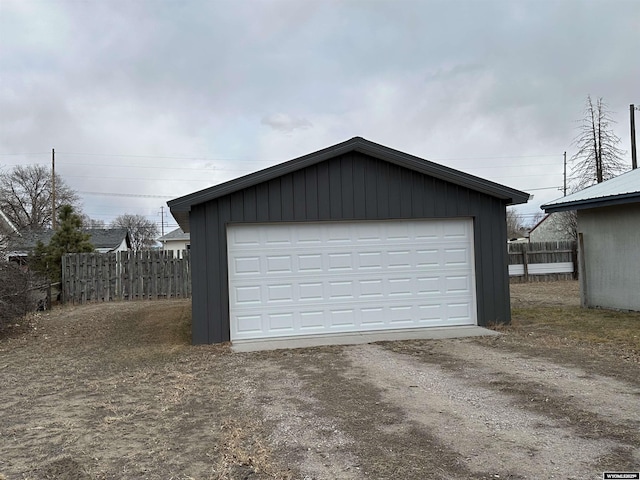 detached garage featuring fence