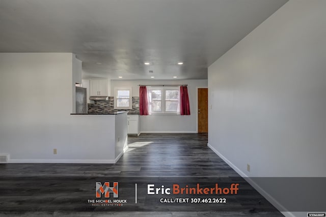 interior space with recessed lighting, visible vents, baseboards, and dark wood finished floors