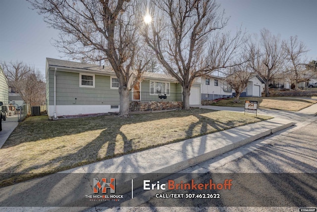 view of front facade with fence, cooling unit, concrete driveway, an attached garage, and a front yard