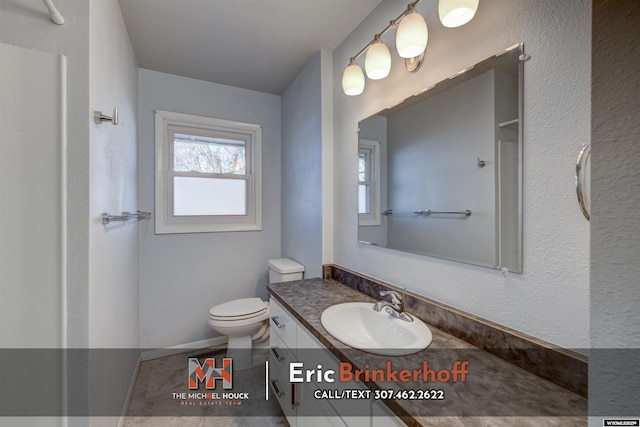 bathroom featuring toilet and vanity