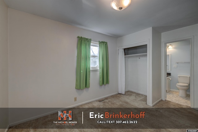 unfurnished bedroom with baseboards, visible vents, carpet floors, ensuite bath, and a closet