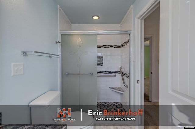 bathroom with a shower stall, toilet, and recessed lighting