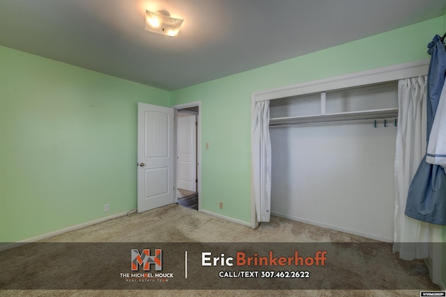 unfurnished bedroom featuring a closet, carpet flooring, and baseboards