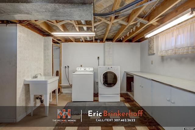 clothes washing area featuring washer and clothes dryer and cabinet space