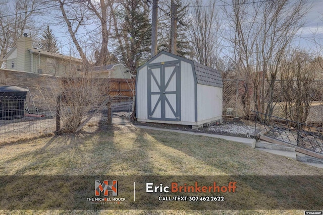 view of shed featuring fence