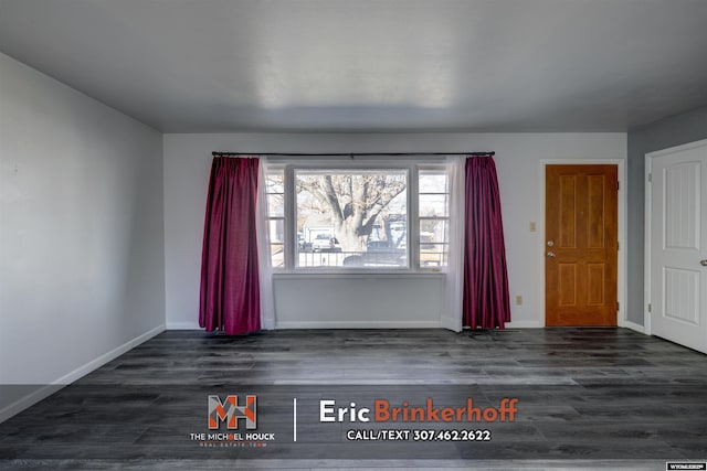 interior space featuring baseboards and wood finished floors