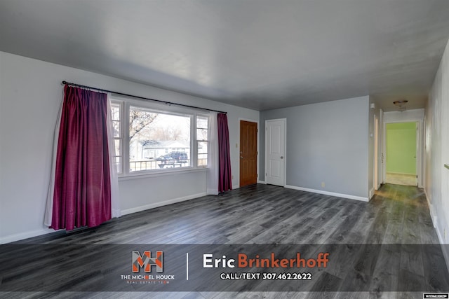 empty room featuring wood finished floors and baseboards