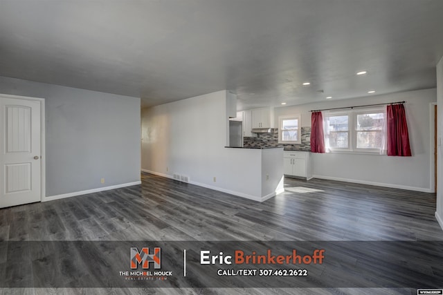 unfurnished living room with recessed lighting, visible vents, baseboards, and dark wood-style flooring