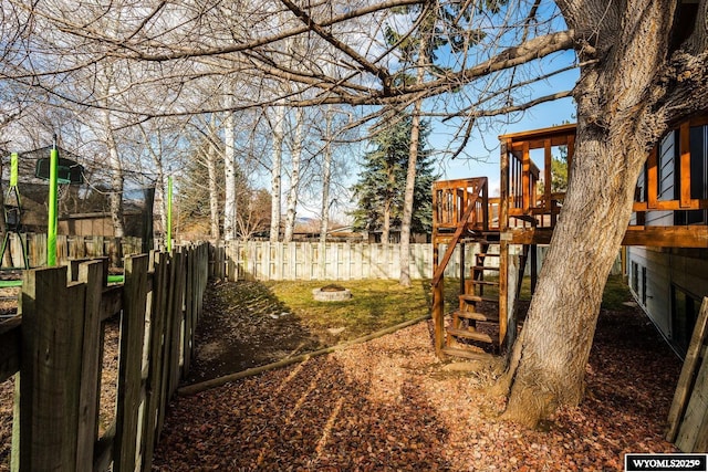 view of yard with a playground and fence