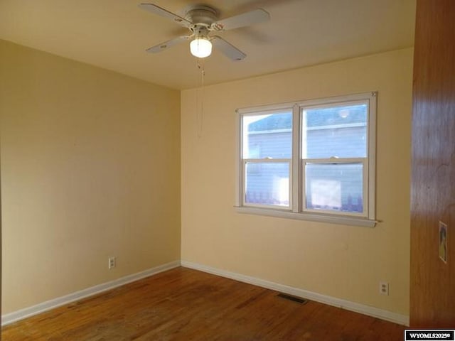 1711 Elk Ave, Casper, WY 82601 - empty room featuring ceiling fan, visible vents, baseboards, and wood finished floors