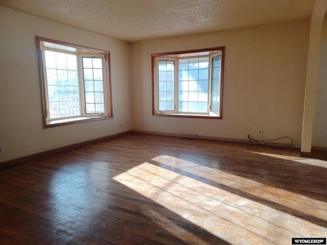 1711 Elk Ave, Casper, WY 82601 - empty room with baseboards, a textured ceiling, and wood finished floors