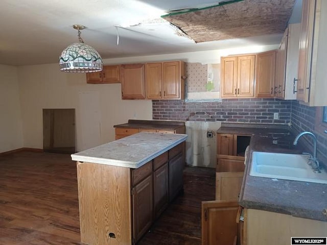 1711 Elk Ave, Casper, WY 82601 - kitchen featuring a sink, tasteful backsplash, dark wood finished floors, and hanging light fixtures