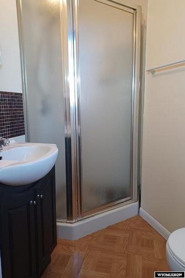 1711 Elk Ave, Casper, WY 82601 - full bath with toilet, a stall shower, vanity, and baseboards
