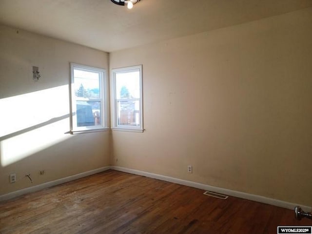 1711 Elk Ave, Casper, WY 82601 - unfurnished room featuring visible vents, baseboards, and wood finished floors