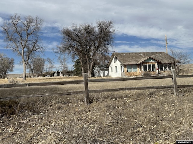 100 Dubuque Ave, Fort Laramie, WY 82212 - view of front facade with a fenced front yard