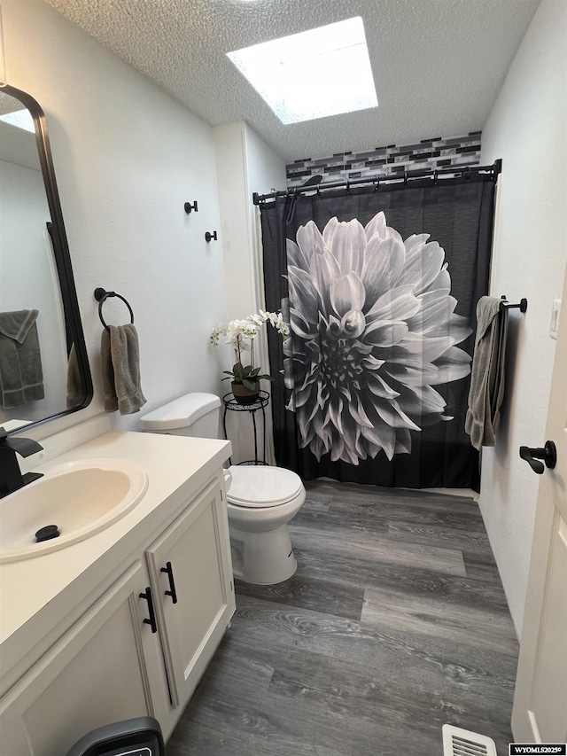 42 Carothers Ave, Fort Bridger, WY 82933 - full bathroom with a shower with curtain, a textured ceiling, vanity, wood finished floors, and a skylight