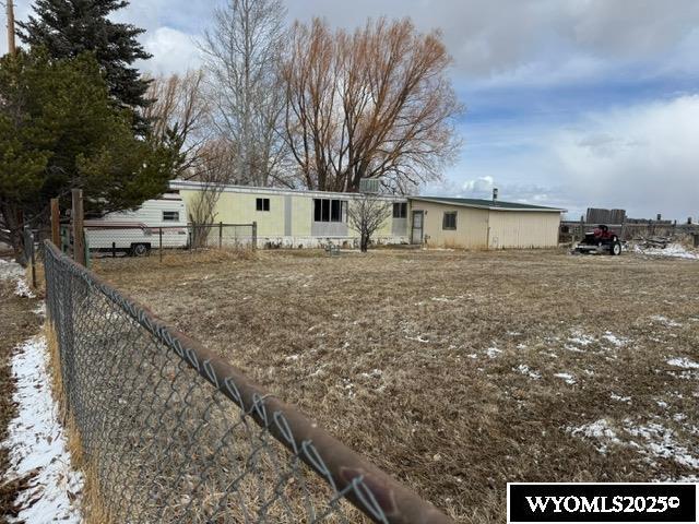 back of property with fence