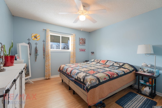 1242 Frontier Dr, Douglas, WY 82633 - bedroom featuring light wood-style flooring, a ceiling fan, baseboards, and a textured ceiling