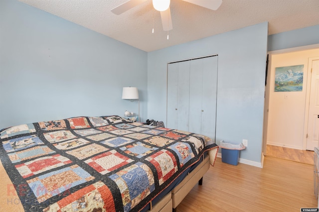 1242 Frontier Dr, Douglas, WY 82633 - bedroom with baseboards, light wood-style floors, a closet, a textured ceiling, and a ceiling fan