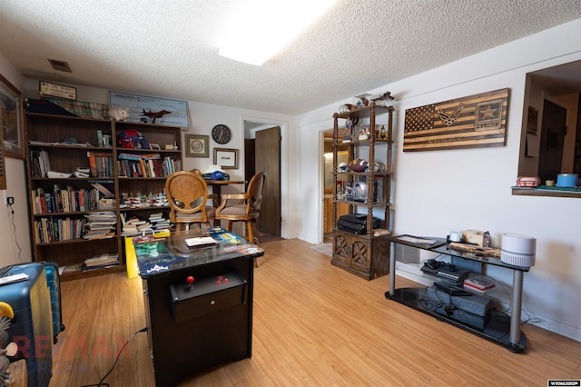 1242 Frontier Dr, Douglas, WY 82633 - office area with visible vents, a textured ceiling, and wood finished floors