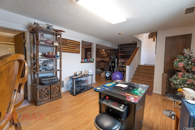 1242 Frontier Dr, Douglas, WY 82633 - playroom with light wood-type flooring, a textured ceiling, and visible vents