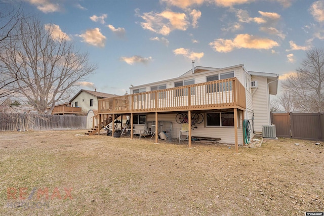 1242 Frontier Dr, Douglas, WY 82633 - back of house at dusk with central air condition unit, a wooden deck, a fenced backyard, and stairway