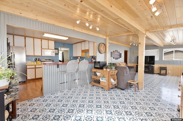 1242 Frontier Dr, Douglas, WY 82633 - living room with wooden walls, beam ceiling, track lighting, wood ceiling, and tile patterned floors