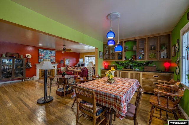dining space featuring ceiling fan and light wood-style flooring