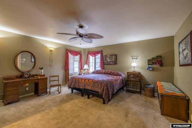 carpeted bedroom featuring baseboards and a ceiling fan