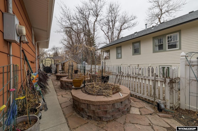 view of patio / terrace featuring a fire pit and fence
