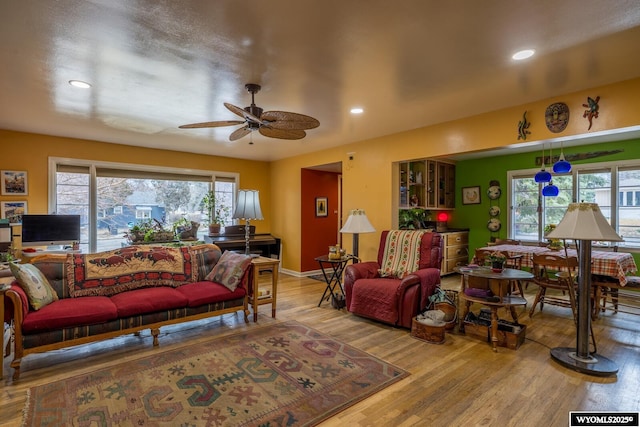 living area featuring plenty of natural light, recessed lighting, a ceiling fan, and wood finished floors