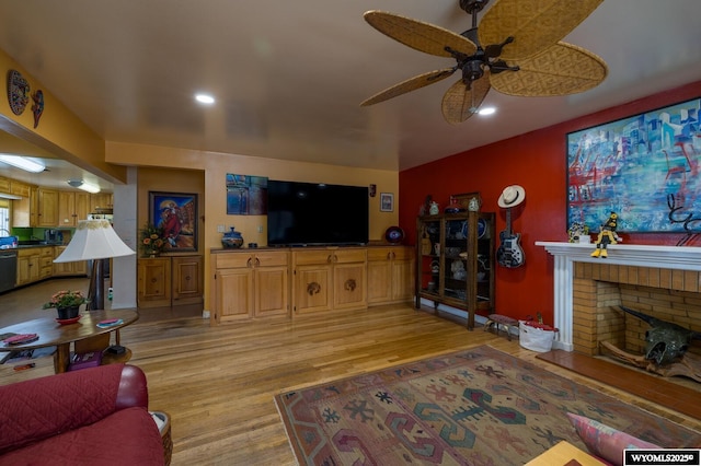 living room with recessed lighting, light wood-style floors, a brick fireplace, and ceiling fan