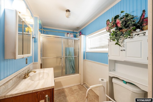 368 N Bozeman Ave, Buffalo, WY 82834 - bathroom featuring a wainscoted wall, bath / shower combo with glass door, vanity, and toilet