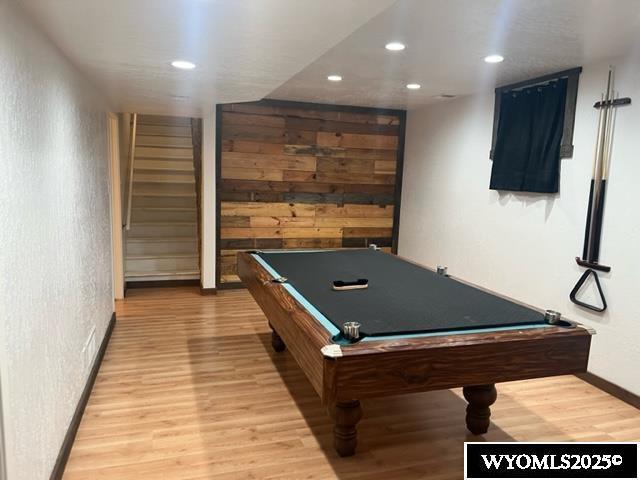 recreation room with wood walls, recessed lighting, baseboards, light wood finished floors, and billiards