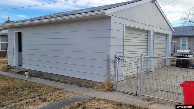 garage with a gate and fence