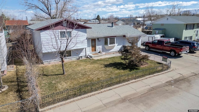 347 Copper, Evansville, WY 82636 - view of front of property with a fenced front yard, driveway, a shingled roof, and a front yard
