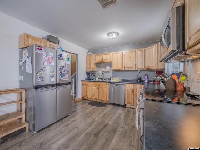347 Copper, Evansville, WY 82636 - kitchen featuring a sink, dark countertops, visible vents, and stainless steel appliances