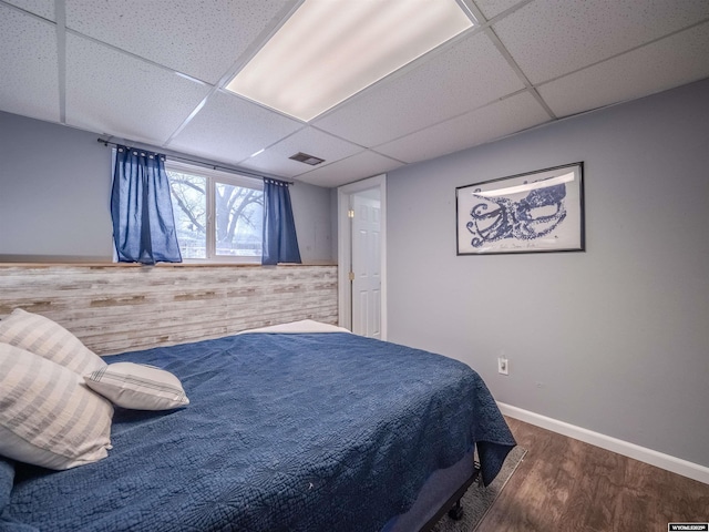 347 Copper, Evansville, WY 82636 - bedroom featuring visible vents, a paneled ceiling, baseboards, and wood finished floors